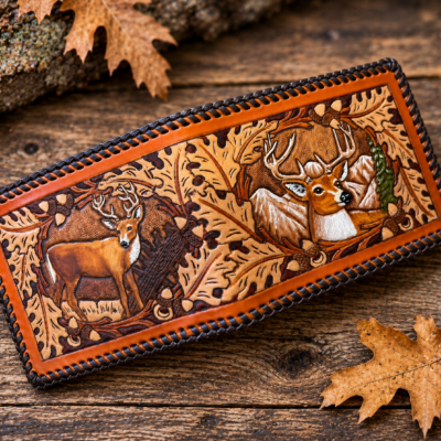 Hand-tooled deer leather wallet featuring two whitetail deer and oak leaf wildlife artwork