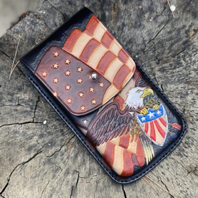 “Custom hand-tooled leather bald eagle American flag cell phone holster. Patriotic belt-mounted case with secure snap closure. Premium USA-made iPhone & Android holder. Shop now!”