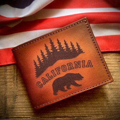 Handcrafted California bifold leather wallet featuring engraved grizzly bears, pine trees, and state outline. Premium full-grain leather with rich patina. Perfect everyday carry for Golden State pride. 🇺🇸🐻