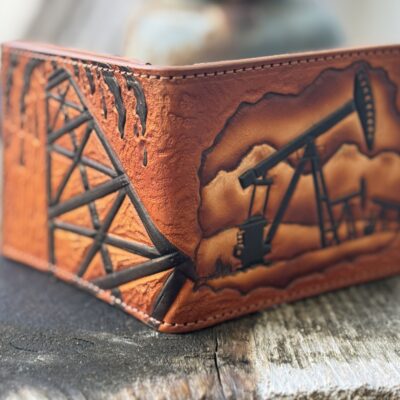 “Custom hand-tooled leather oil rig wallet with pumpjack & oil derrick design. Rugged bifold billfold for oilfield workers. Premium handcrafted oilfield gift. Shop now!”