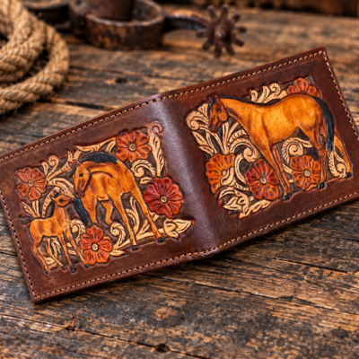 A classic design equestrian wallet - a hand tooled western floral design with horses on the front and back.