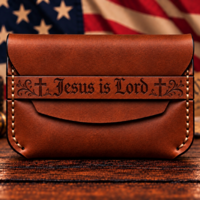 Shop a handcrafted russet brown leather card holder featuring Jesus Is Lord engraving, traditional crosses, and decorative scrollwork. A distinctive Christian gift.